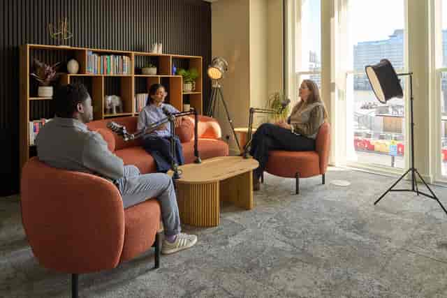 Podcast and fireside chat breakout space with lounge seating for professional event production.