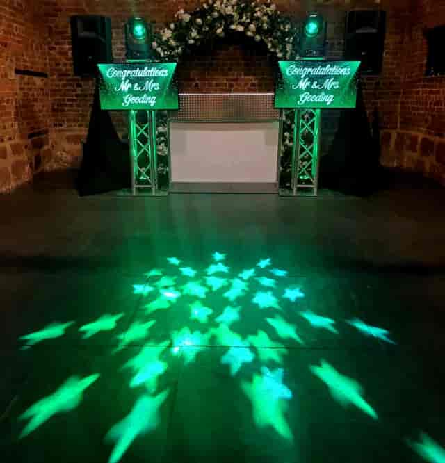 DJ setup with gobo lighting in rustic Moseley Community Hub for wedding and party venue hire.