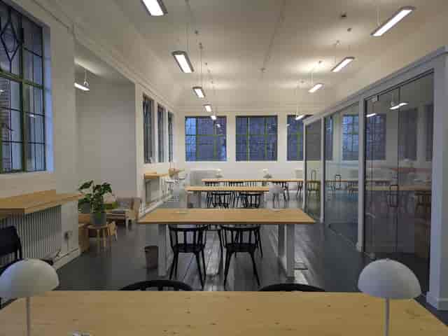 Modern coworking assembly hall with natural light for collaborative workshops and event hire.