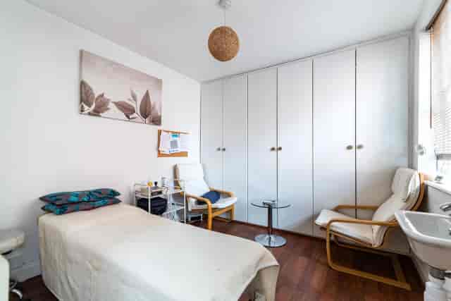 Sapphire therapy room with private seating, perfect for wellness sessions and one-on-one consulting.