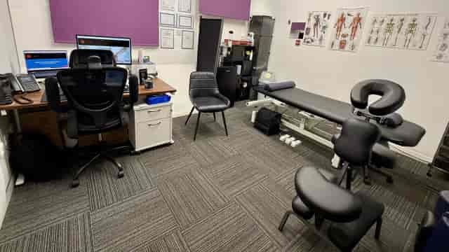 Sapphire clinical therapy room with medical equipment for specialized healthcare consultations.