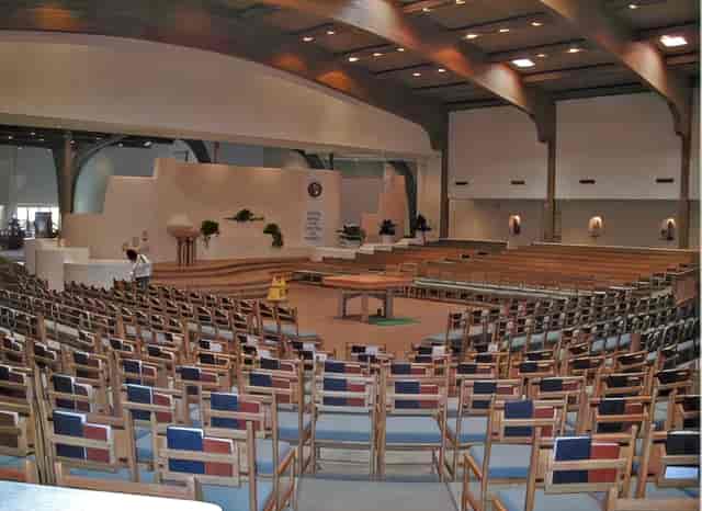 Theater-style seating in New Life Baptist Church hall for church events and community conferences.