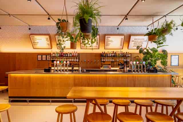 Bird House Brewery taproom with communal seating for corporate happy hours and networking events.