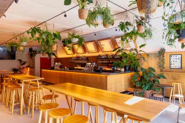 Bird House Brewery taproom, biophilic design, ideal for networking mixers and team socials.