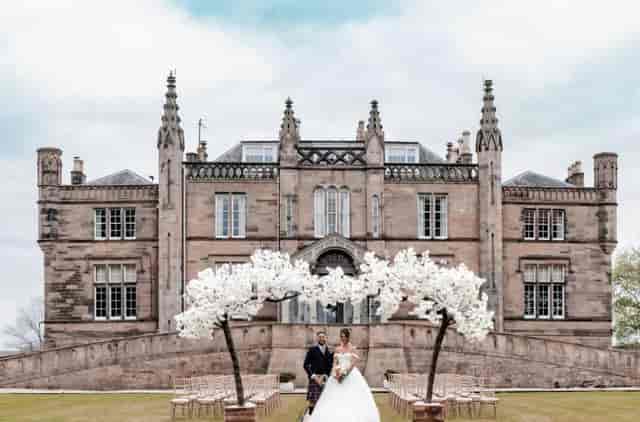 Luxury outdoor wedding ceremony at Powfoulis Manor Hotel featuring formal floral installations.