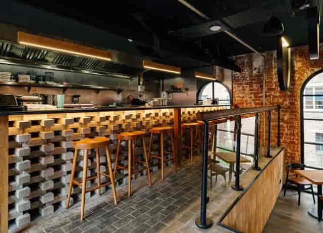Industrial-chic Maneki Ramen venue with tiered seating for networking events or private dining.