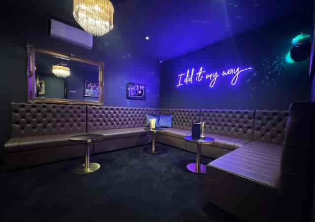 Exclusive private venue with neon lighting for corporate networking and post-conference cocktail events.