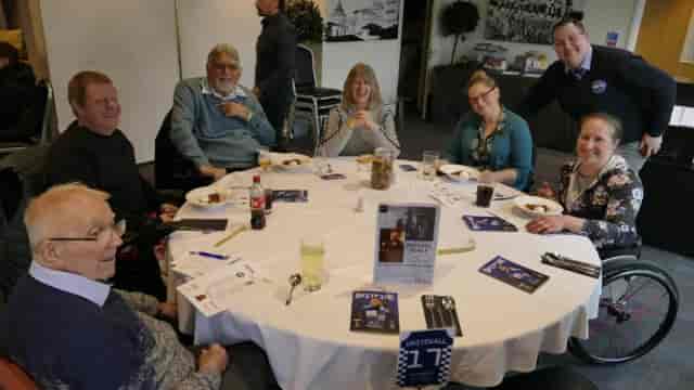 Roundtable luncheon at Sherwoods function room, featuring branded collateral for donor events.