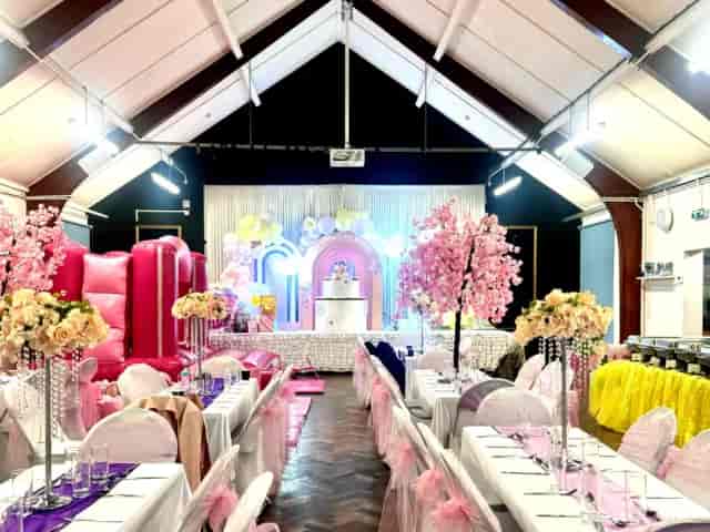 Themed event stage with floral decor and bouncy castle at Haverstock School venue.