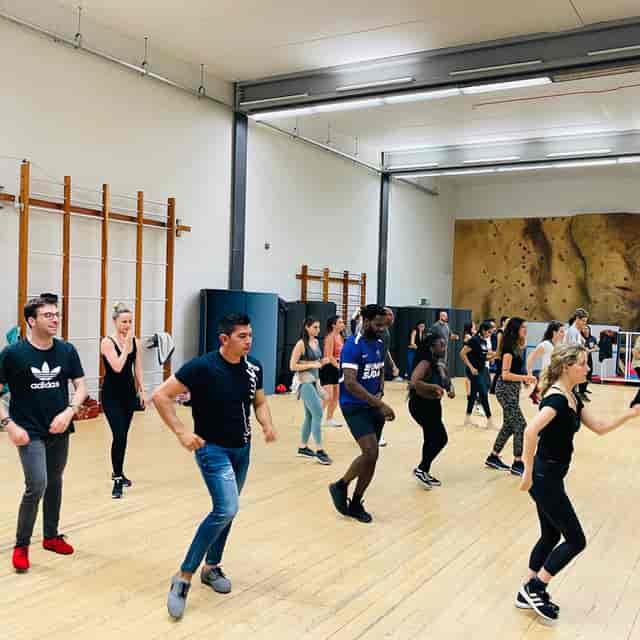 Corporate wellness team-building session in a Haverstock School dance studio.