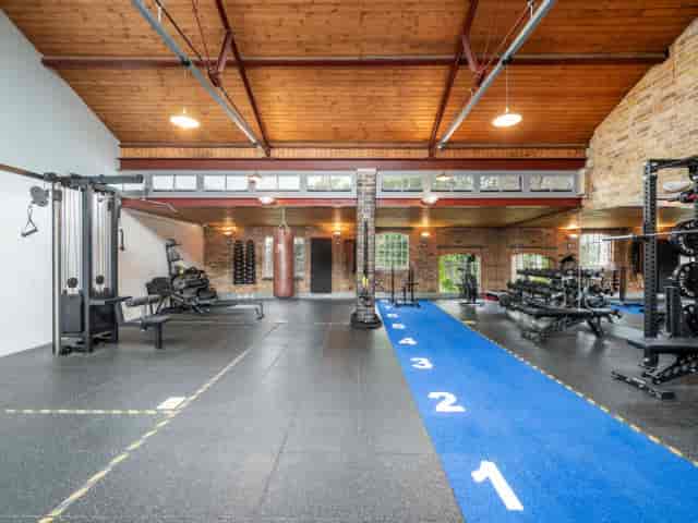 Industrial-chic Main Hall fitness studio for corporate retreats and team-building workshops.