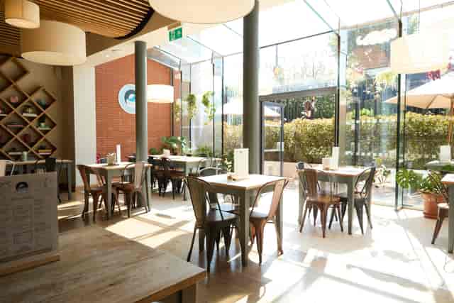 Bright Café and Studio at The Maqam Centre with floor-to-ceiling glass for networking and events.