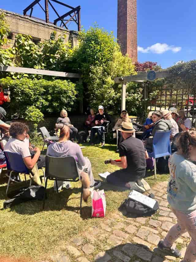 Circular seating for an outdoor workshop breakout session at Meanwhile Gardens Playhut venue.