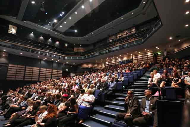The Hawth Main Auditorium tiered theater set for a keynote presentation and plenary session.