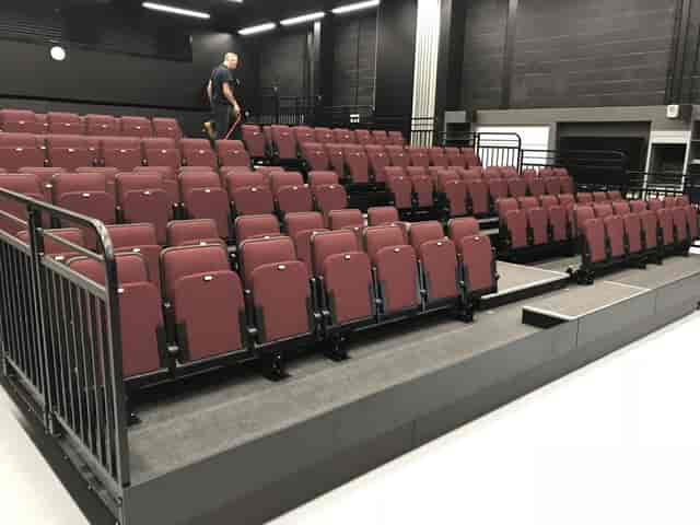 Main Auditorium at The Hawth with plush tiered seating for corporate presentations and theater events.