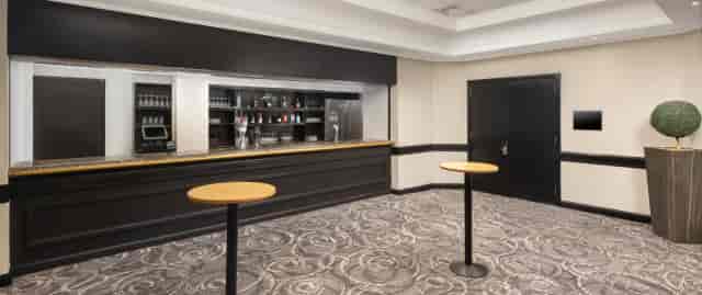 Foyer exhibition space at The Hawth with built-in bar, perfect for cocktail receptions and networking.