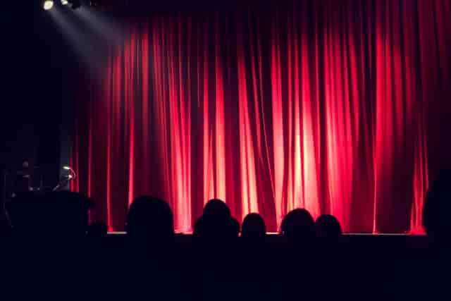 Keynote opener at Myers Studio, Epsom Playhouse with stage lighting and engaged audience.