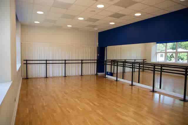 Studio 1 at Chequer Mead Theatre with mirrored wall for yoga sessions and team-building workshops.