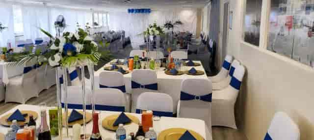 Banquet setup at Main Event Hall with blue sashes for weddings and social events.