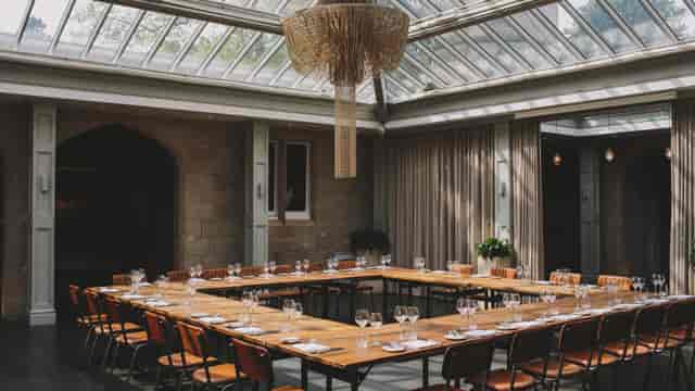 U-shape meeting room with glass ceiling, perfect for corporate executive meetings and workshops.