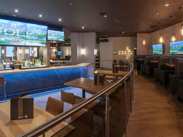 Modern Shark Club lounge for corporate happy hours and networking events with AV screens.