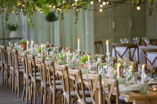Chic long-table event setup at The Bridoon Solihull with bistro lighting for rustic wedding decor.