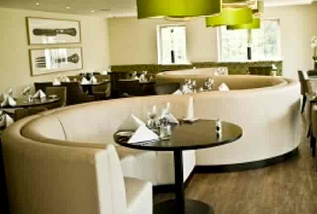 Contemporary dining at The Coach House Hogarths with curved banquette seating for events.