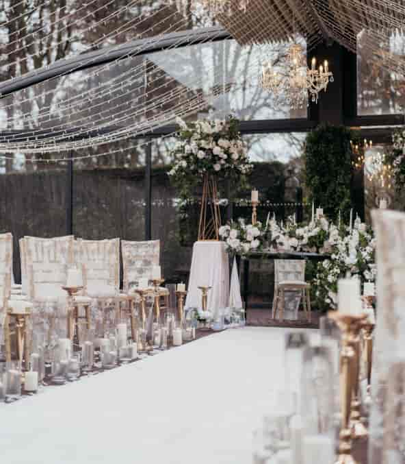Delamere Manor wedding ceremony with floral focal point and fairy-light decor.