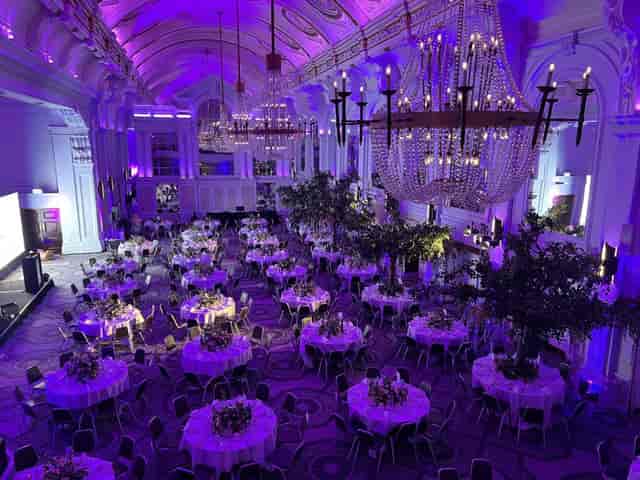 Ballroom at The Crown Regency Solihull with purple lighting and crystal chandeliers for gala dinner.