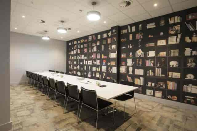 Boardroom meeting space at VWorks Solihull with library feature wall for strategy sessions.