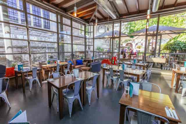 Industrial-chic dining room with modular seating for networking receptions and corporate lunches.
