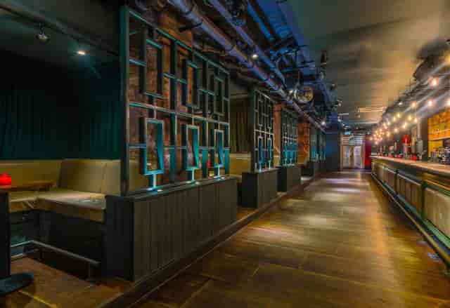 Industrial-chic Vodka Studio venue with modular booth seating for networking and cocktail events.