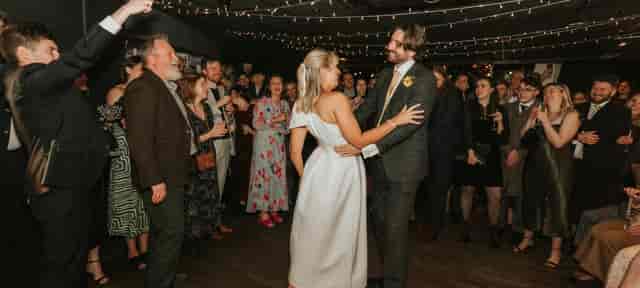 Wedding reception at Revolution America Square with string lighting and dance floor.
