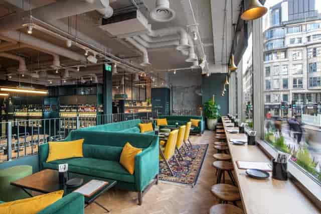 Industrial-chic breakout space with lounge seating, ideal for corporate events and networking.