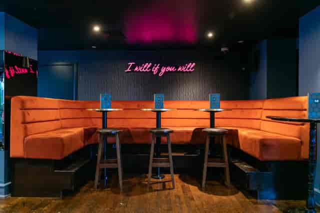 Basement Bar at Be At One Monument with neon decor for exclusive networking and VIP events.