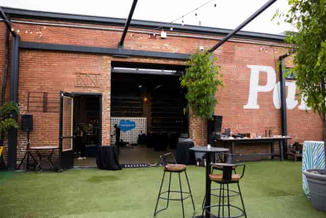 Industrial-chic Be At One Monument bar with stage for corporate networking and cocktail events.
