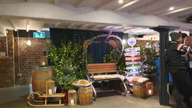 Après-ski themed photo booth at Munich Cricket Club with rustic props for event branding.