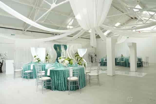 Canvas Studios open plan event space with teal tables and ceiling drapery for corporate events.