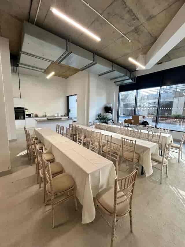 Industrial open plan event venue with banquet seating for workshops and corporate training.