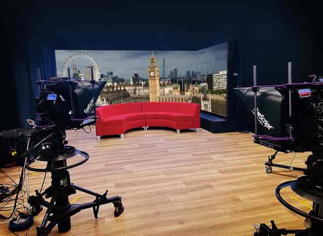 Soundproofed podcast studio with LED backdrop for professional hybrid events and executive panels.