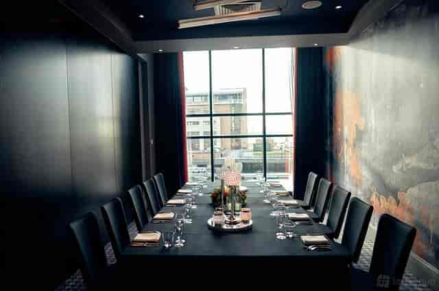 Fusion Room 2: Modern boardroom with feature wall for executive meetings and private events.