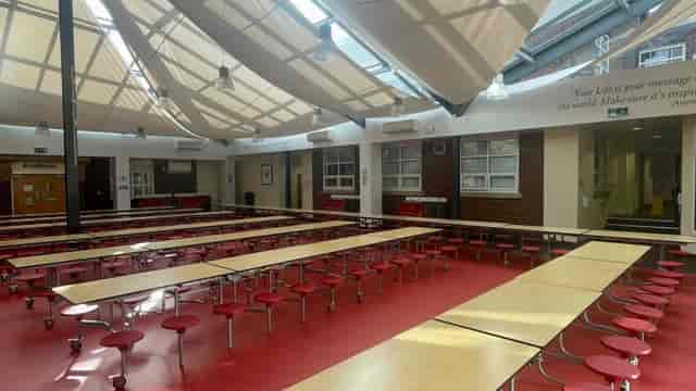 Modern school training room with bench seating, ideal for corporate workshops and seminars.