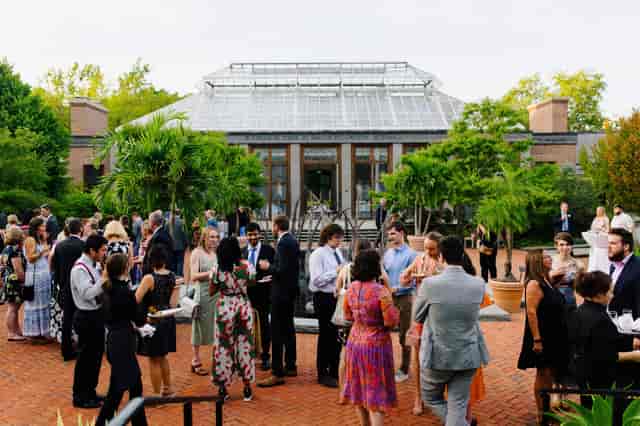 Outdoor cocktail reception at Southwick botanical venue with architectural focal point.