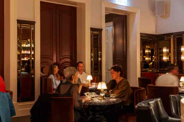 Intimate VIP lounge with warm lighting for private corporate dinners and networking events.