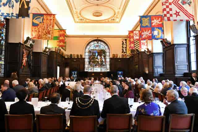 Banquet in historic Maset livery hall with long table layout for corporate events or weddings.