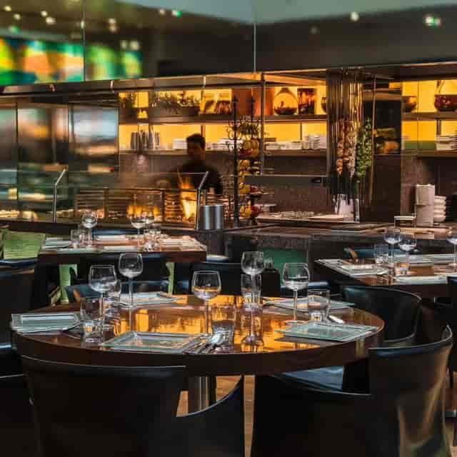Live-fire open kitchen at Morchella wine bar, ideal for corporate dining and VIP gala events.