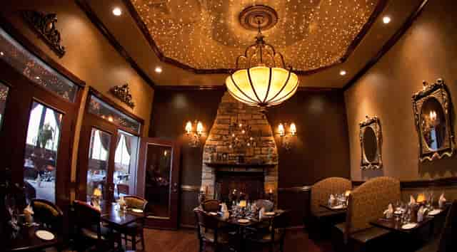 VIP dinner venue with stone fireplace and starlit ceiling for exclusive events.