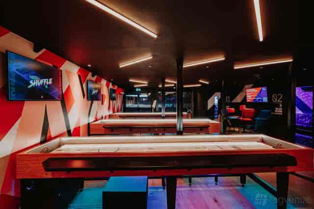 Mezzanine area at PLAYBOX Croydon with shuffleboard, ideal for corporate team building events.