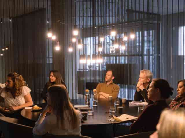 Executive boardroom at PLAYBOX Croydon featuring a circular table for corporate meetings.