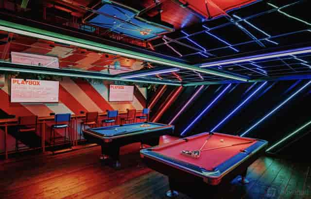 Neon-lit Mezzanine area at Playbox Croydon, ideal for interactive corporate team building events.